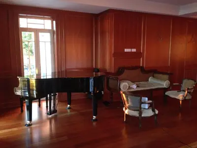 a living room with a piano and a couch at Quinta Paços do Lago in Funchal