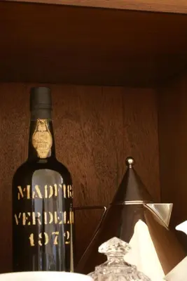 a bottle of wine sitting next to a glass at Quinta Paços do Lago in Funchal