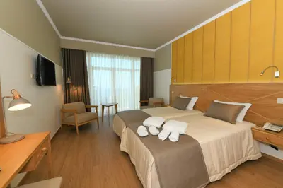 a hotel room with a bed with towels on it at Hotel Do Campo in Ribeira Brava