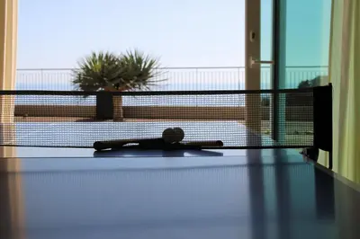 a remote control on a table in front of a window at Hotel Do Campo in Ribeira Brava