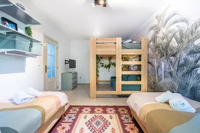 two beds in a room with a bunk bed at Casa Skip in Aljezur