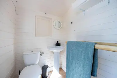 a small bathroom with a toilet and a sink at Casa Skip in Aljezur