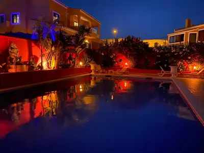 a bedroom with a large bed and a table with a yellow chair at Casa Concha - Peaceful and Relaxing in Lagos