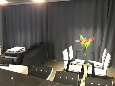 a room with a couch and a table with a vase of flowers at Villa Pinheira II in Estreito da Calheta