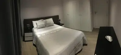 a bedroom with a large bed with white sheets and pillows at Villa Pinheira II in Estreito da Calheta