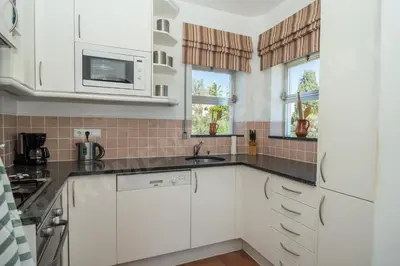a kitchen with white cabinets and a sink at Seaview Apartment H in Luz