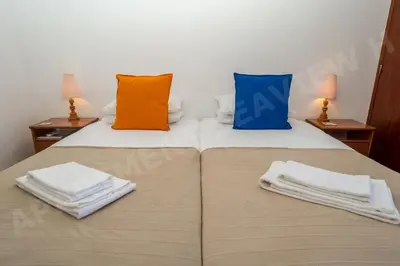 two beds in a room with towels on them at Seaview Apartment H in Luz