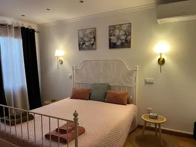 a bedroom with a bed and two pictures on the wall at Casa dos Avos in Calheta