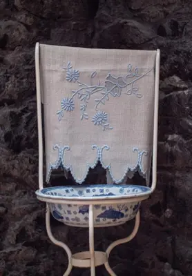 a blue and white chair with a blanket on it at Casa dos Avos in Calheta
