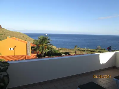 a view of the ocean from the balcony of a house at Beachfront House Atalaia in Caniço