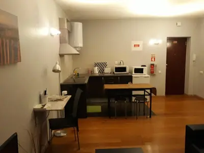 a kitchen with a table and chairs in a room at Apartamentos América - Blue Sea in Funchal