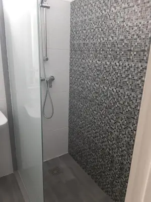 a bathroom with a shower with a glass door at Apartamentos América - Blue Sea in Funchal
