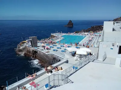a swimming pool on the side of the ocean at Apartamentos América - Blue Sea in Funchal