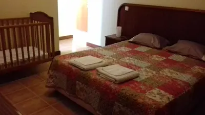 a bedroom with a bed with two towels on it at Apartamento Arrifes in Porto Santo