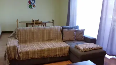 a living room with a couch and a table at Apartamento Arrifes in Porto Santo