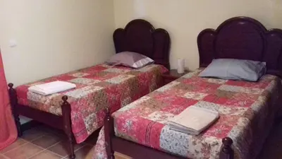 two beds sitting next to each other in a room at Apartamento Arrifes in Porto Santo