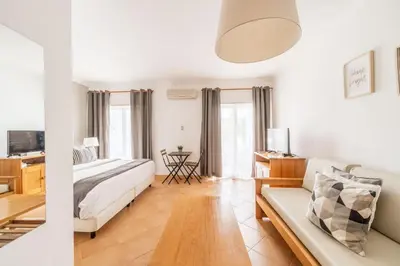 a living room with a bed and a couch at Oasis Beach Apartments in Luz