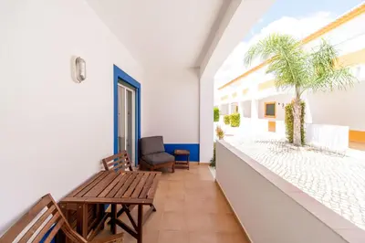 a hallway with a bench and a table at Oasis Beach Apartments in Luz