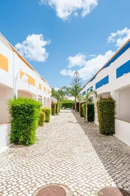 a cobblestone street in front of a building at Oasis Beach Apartments in Luz