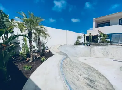 a concrete skateboard ramp in front of a house at Casa Biota in Sagres