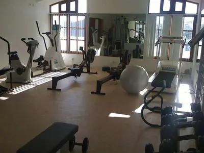 a gym with several treadmills and exercise bikes at Apartamentos Os Descobrimentos in Burgau