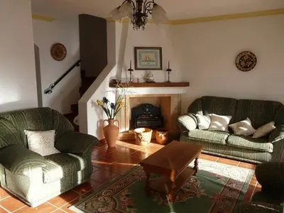a living room with two couches and a fireplace at Apartamentos Os Descobrimentos in Burgau