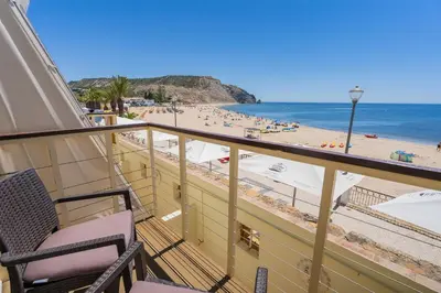 a balcony with a view of a beach and the ocean at Luz Beach Apartments in Luz