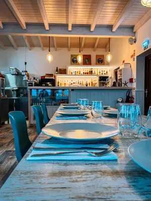 a table with plates and napkins on it in a restaurant at Barranco da Fonte in Chabouco