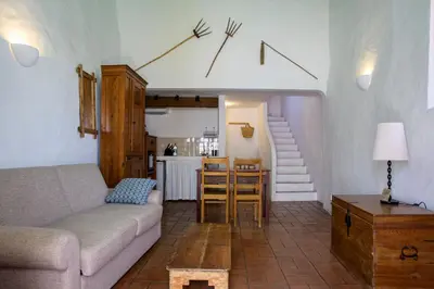 a living room with a couch and a table at Aldeia da Pedralva by WOT Signature in Vila do Bispo