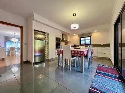 a kitchen and dining room with a table and chairs at Casa Saramago by AnaLodges in São Vicente