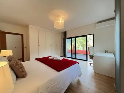 a bedroom with a bed with a red blanket on it at Casa Saramago by AnaLodges in São Vicente