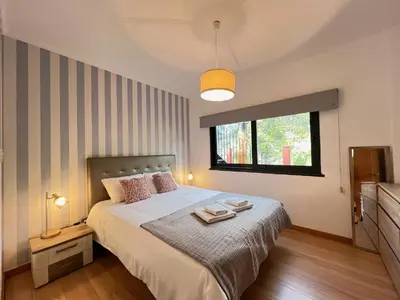 a bedroom with a bed with two towels on it at Casa Saramago by AnaLodges in São Vicente