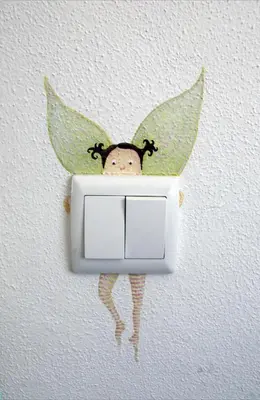 a switch with a monkey hanging on a wall at Luz House in Luz