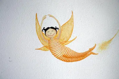 a drawing of a mermaid on a wall at Luz House in Luz