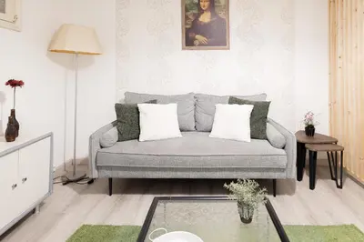 a living room with a couch and a glass table at The House in Funchal