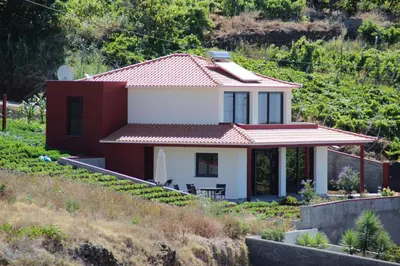 a house on the side of a hill at Villa Pinheira I in Calheta