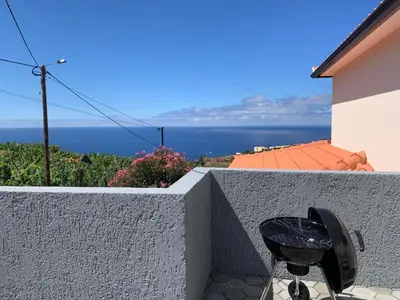 a black grill sitting on the side of a wall at Villa Pinheira I in Calheta