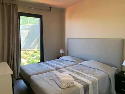 a bedroom with a bed with two towels on it at Villa Pinheira I in Calheta