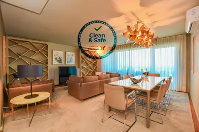 a dining room and living room with a table and chairs at Apartamento Astrolab in Funchal