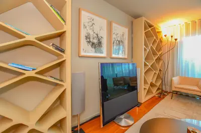 a living room with shelves and a tv at Apartamento Astrolab in Funchal