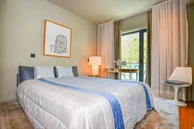 a bedroom with a bed and a large window at Apartamento Astrolab in Funchal