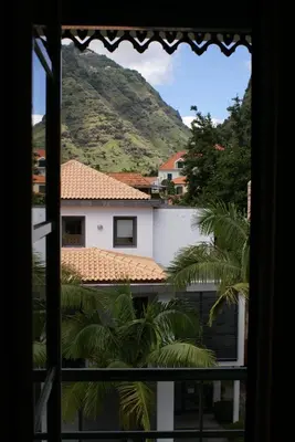 a view of a mountain from a window at Loft Paços da Vila in Ribeira Brava