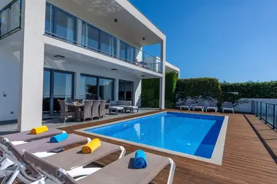 a villa with a swimming pool and a house at Villa Enjoy - by LovelyStay in Lombo da Velha