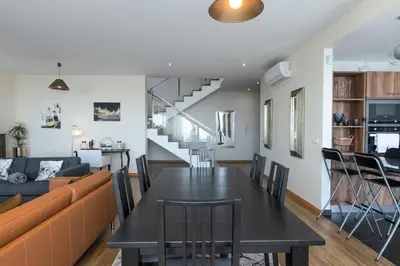 a villa with a swimming pool and a dining table at Villa Enjoy - by LovelyStay in Lombo da Velha