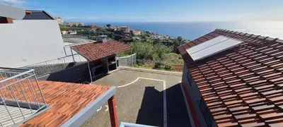 arial view of a roof of a house with the ocean at Adega do Avô 2 Madeira in Estreito da Calheta