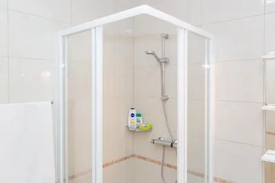 a shower with a glass door in a bathroom at Atlantic Rose in Calheta