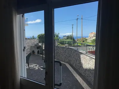 a sliding glass door with a view of a balcony at Atlantic Rose in Calheta