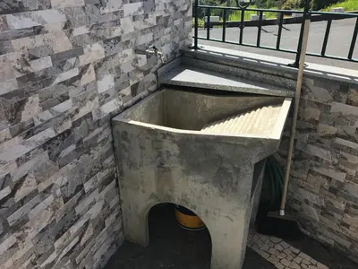 a concrete tub sitting next to a brick wall at Atlantic Rose in Calheta