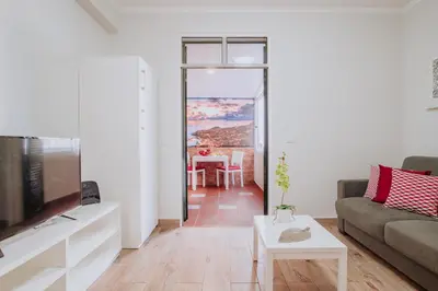 a living room with a couch and a table at Funchal City Apartments in Funchal