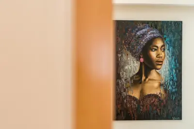 a painting of a woman in a headdress on a wall at Welcome Madeira Apartments by Wanderlust Madeira in Funchal
